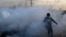 Palestine -- Palestinian press photographers run amidst tear gas smoke during clashes with Israeli forces on December 11, 2017 near the border fence with Israel, east of Gaza City.