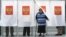 Russia -- A woman holds her ballot while leaving a voting booth at a polling station in Moscow, September 18, 2016