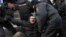 RUSSIA -- Police officers detain a demonstrator after the Free Internet rally in response to a bill making its way through parliament calling for all internet traffic to be routed through servers in Russia, in Moscow, March 10, 2019