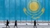 KAZAKHSTAN -- People walk past a gaint Kazakhstan's flag in Astana, March 5, 2019