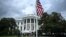 TOPSHOT - US President Donald Trump looks on as a US flag is raised on a newly installed flagpole on the South Lawn of the White House in Washington, DC on June 18, 2025.