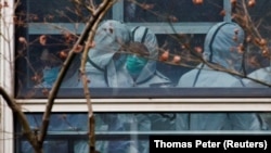 Эксперты ВОЗ во время визита в Ухань. 2 февраля 2021 года. Фото: Reuters