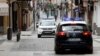 Patrol cars of local police and Spanish National police are seen in the empty shopping La Bola street during the lockdown amid the coronavirus disease (COVID-19) outbreak in Ronda, southern Spain