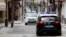 Patrol cars of local police and Spanish National police are seen in the empty shopping La Bola street during the lockdown amid the coronavirus disease (COVID-19) outbreak in Ronda, southern Spain