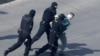 BELARUS -- Police officers detain a man at a planned rally after protesters were prevented from doing so by police, who cordoned off several streets, a main square and park in Minsk, March 27, 2021
