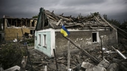 UKRAINE – Ukraіnian flag in front of a partially destroyed building in Irpin, Kyiv region, June 16, 2022